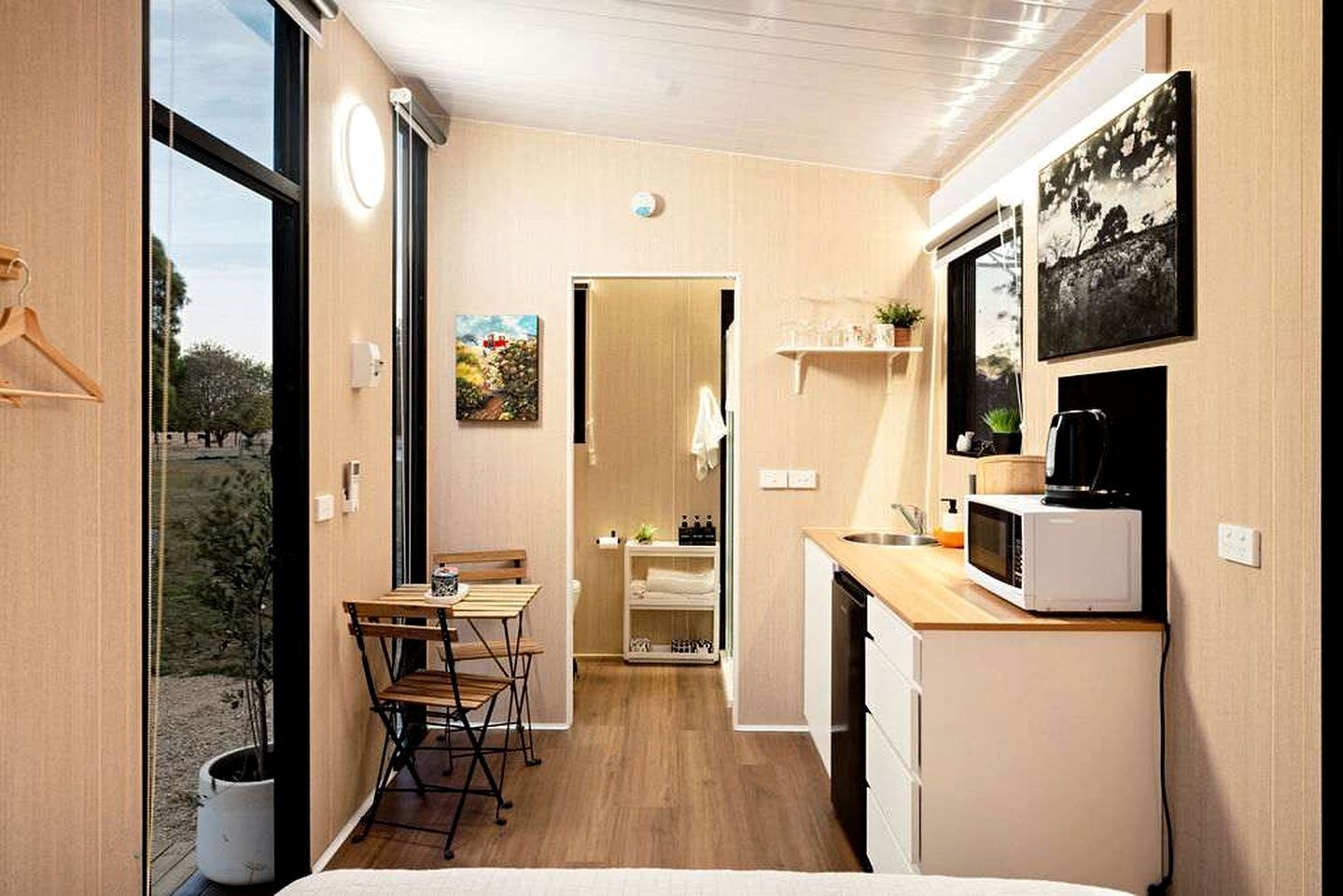 A compact kitchen with a dining area, a microwave, and a small refrigerator.