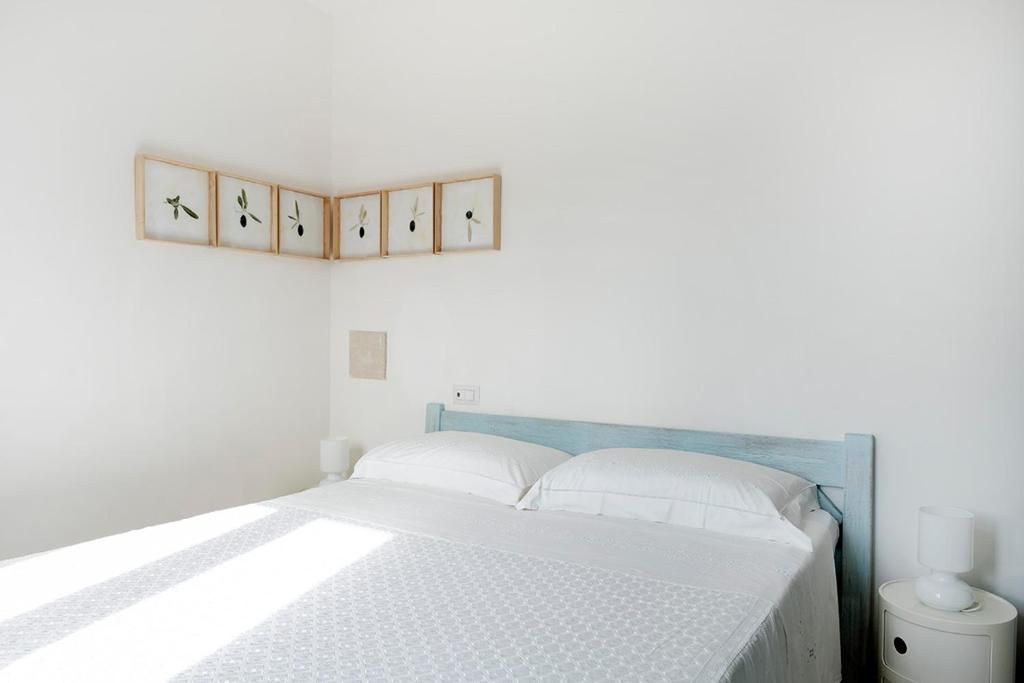 A neatly made bed with a patterned bedspread, a wooden headboard, and a bedside table with a lamp.