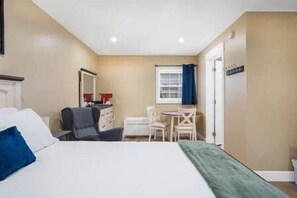 A hotel room with a bed, a desk, and a chair. - Riverside Inn - Unit 2 Accessible (New Glasgow)