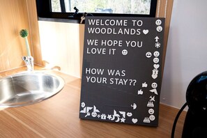 A welcome sign in a room with a sink and a window.