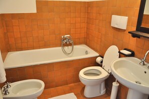 A bathroom with a bathtub, toilet, bidet, and sink. - Montecasciano Girasole (Capranica)