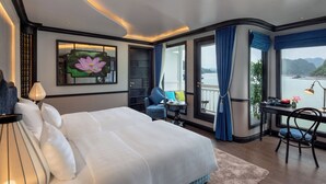 Un dormitorio amplio con una cama grande, un escritorio y vistas a un lago.