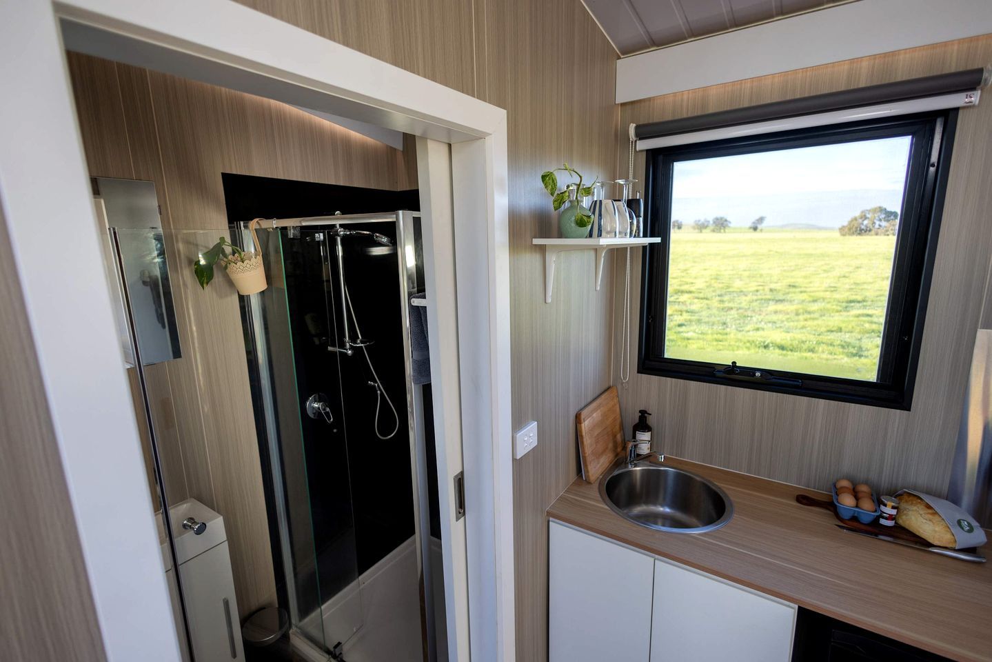 A compact kitchen with a window, a sink, and a small countertop.