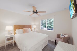 A bedroom with a bed, a nightstand, a chair, a ceiling fan, and a window with blinds. - Private Inland Home | Heated Pool & Near Goodland (Marco Island)