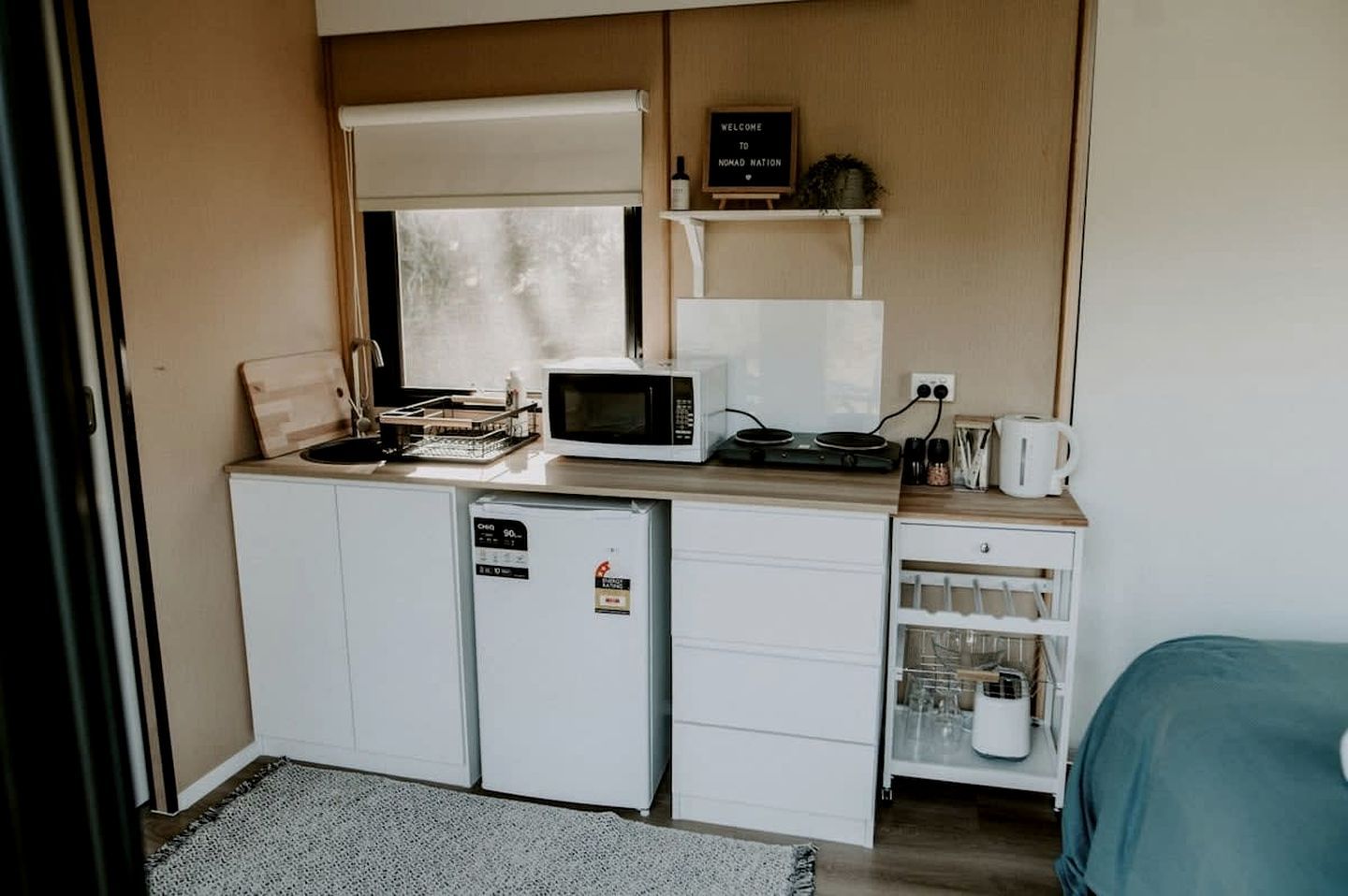 A compact kitchenette with a microwave, a small refrigerator, and a coffee maker.