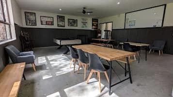 A conference room with a long table, chairs, and a ceiling fan.