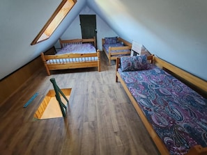 A dormitory room with three wooden bunk beds, a skylight, and a wooden ladder. - Apartment Ursa Major & Glamp Barba (Preddvor)