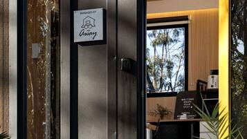 A hotel entrance with a sign indicating management by 'Away.'