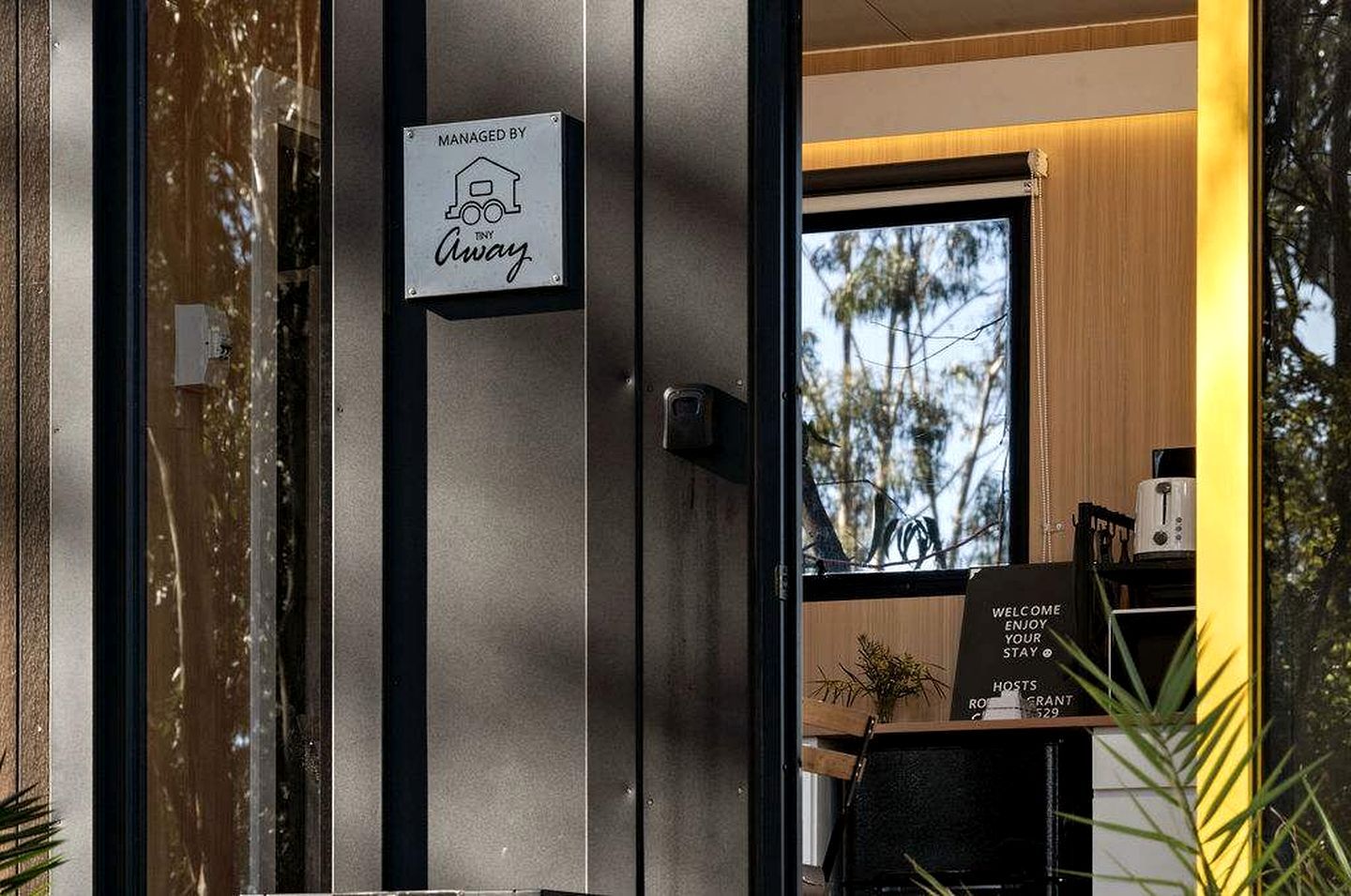 A hotel entrance with a sign indicating management by 'Away.'