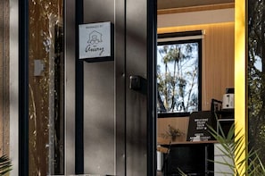 A hotel entrance with a sign indicating management by 'Away.'