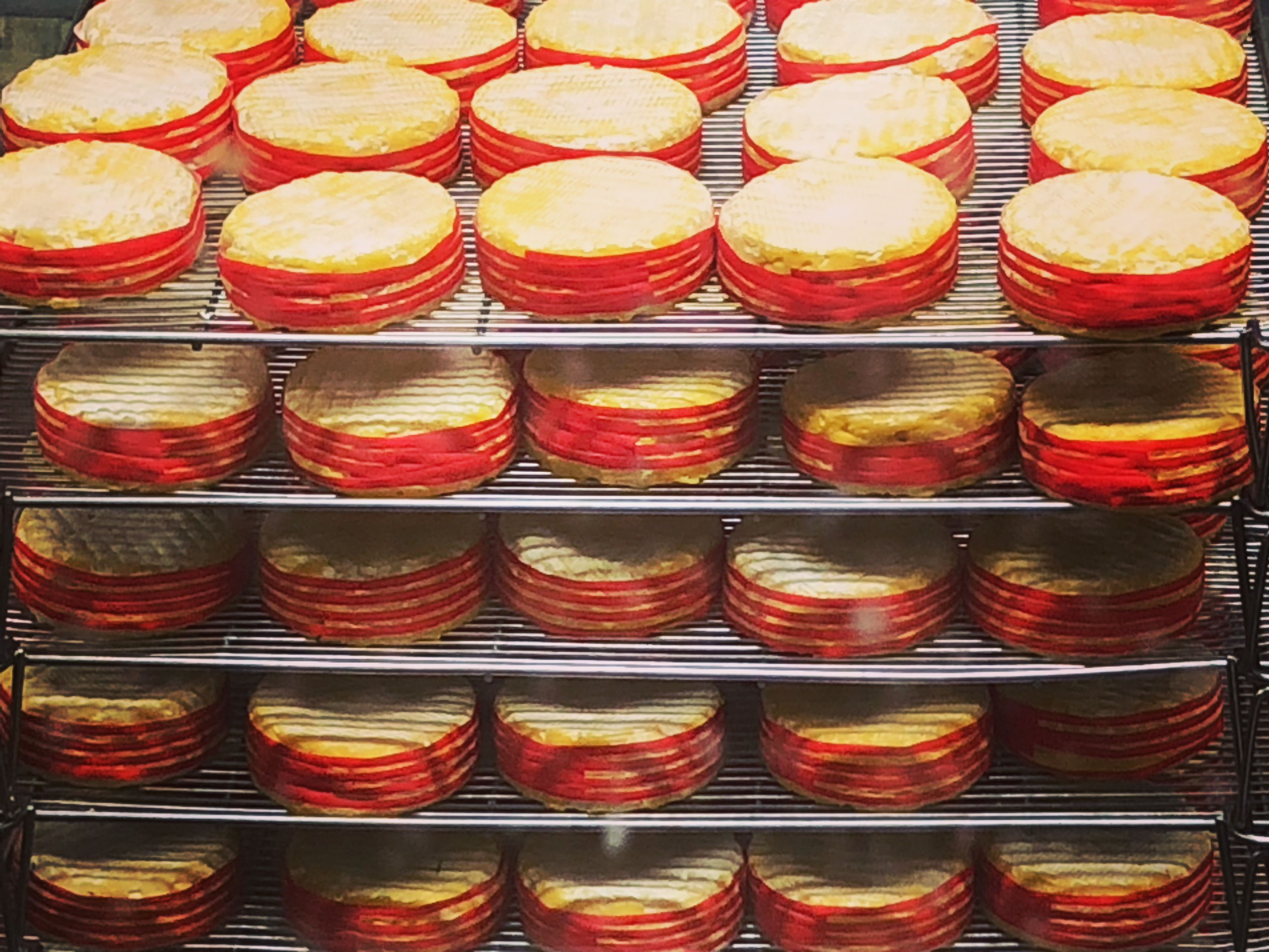 A rack of baked goods, possibly pastries, arranged in rows on a metal rack.