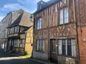 A row of traditional half-timbered buildings with visible brickwork and timber framing.