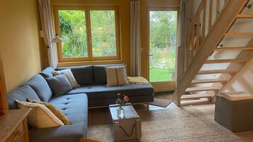 Ein Wohnzimmer mit einer Couch, einem Couchtisch und einer Treppe.