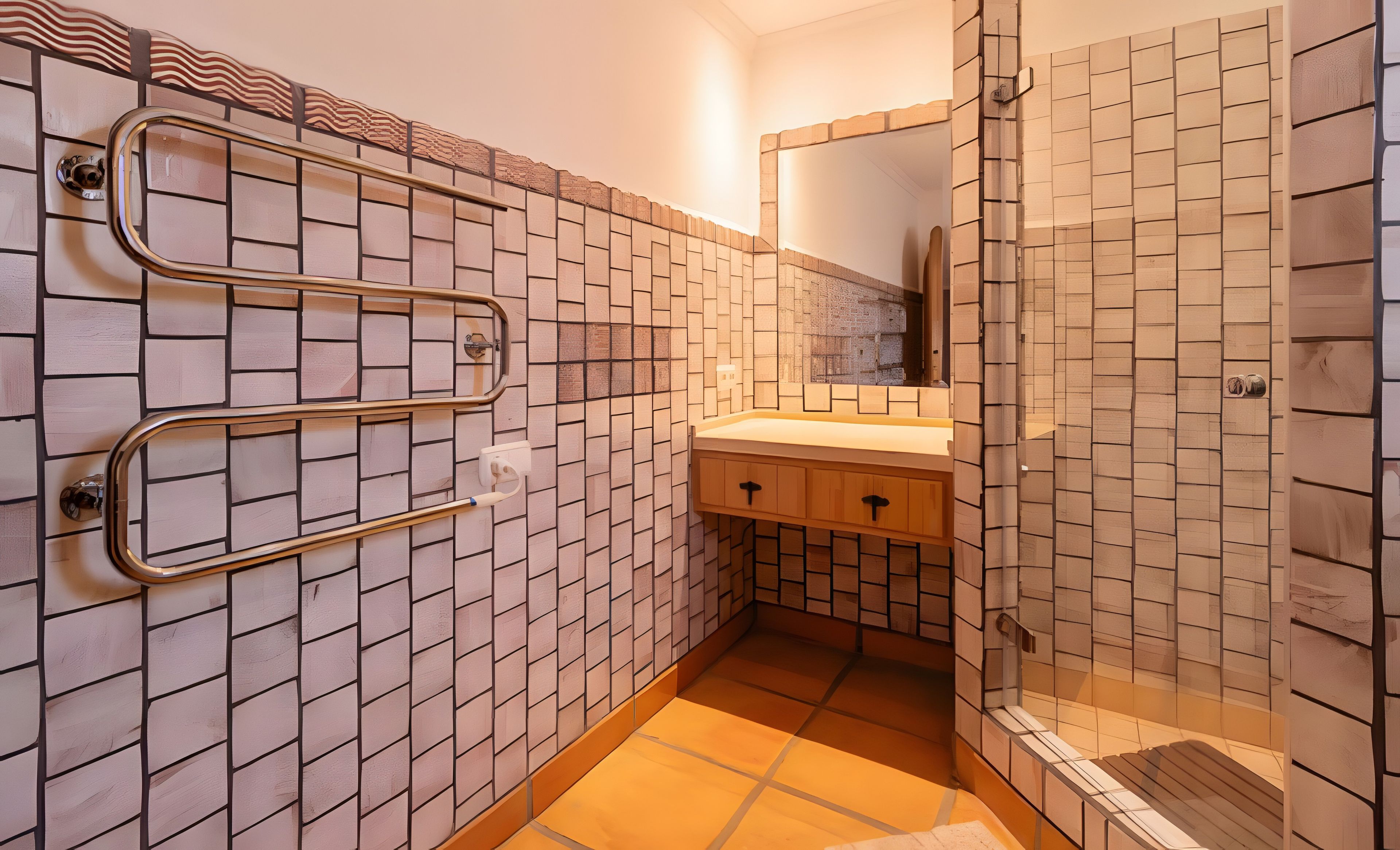 A bathroom with a tiled wall, a sink, and a shower area.