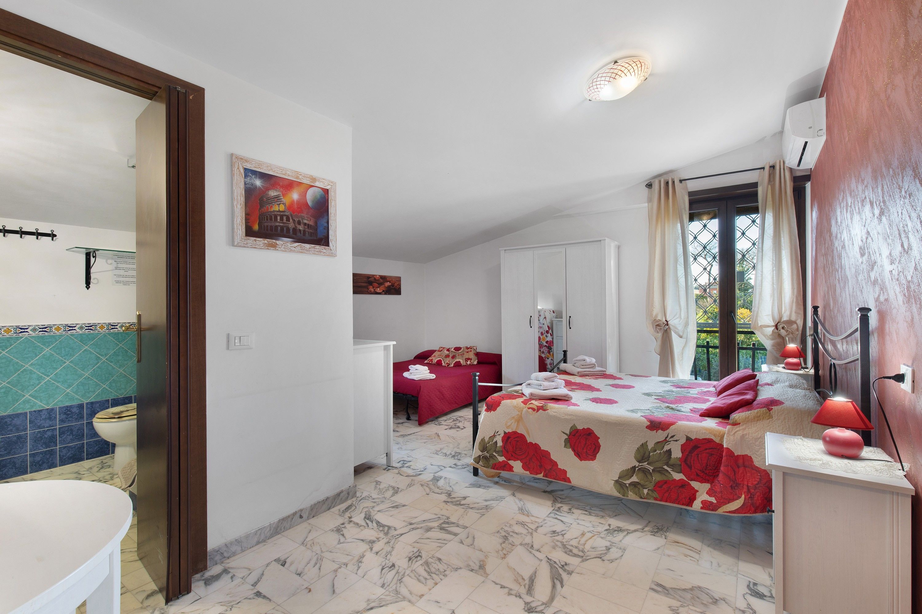 Ein Hotelzimmer mit Bett, Bad und Blick nach außen.