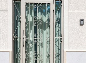 A door with a metal gate and a handle. - Athens Culture Spot near Museum & Park by ΜΡS (Athina)