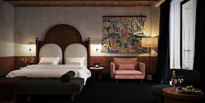 A hotel room with a large bed, a small table with a lamp, a chair, and a decorative tapestry on the wall.