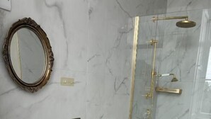 A bathroom with a marble sink, a toilet, and a glass-enclosed shower. - Uppercourt Manor  (Freshford)