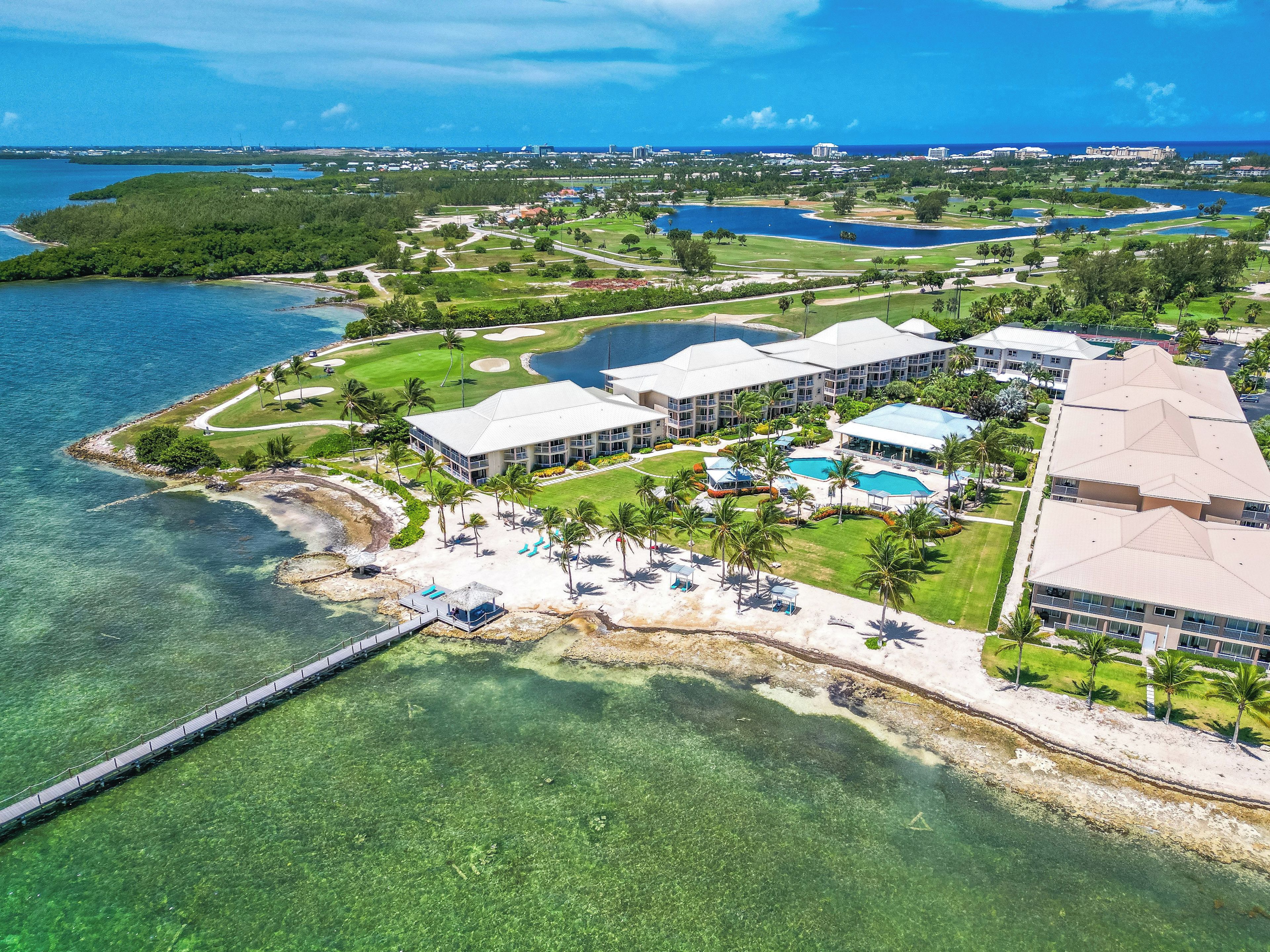 Explore the stunning coastline and nearby greens from above.