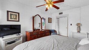 A bedroom with a bed, dresser, television, and a ceiling fan. - Amazing location at Indian Springs Colony 30-day minimum stay (Largo)