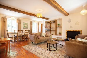 A cozy living room with a sofa, chairs, a coffee table, and a fireplace. - L'Aposée, a country house in Normandy, where nature meets creative experiences (Thury-Harcourt-le-Hom)