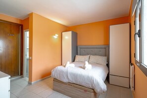 A hotel room with a bed, a wardrobe, a bedside table, and a window. - Holiday Home in Nerja With Sea Views (Nerja)