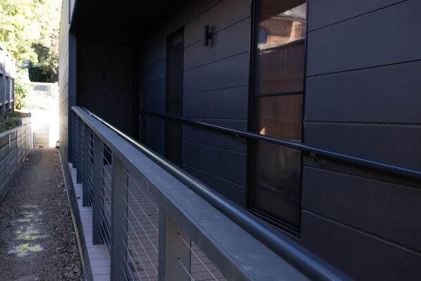 A modern building with a metal railing and a window with a dark blind. - #4 PIPER ST COLLECTION - LUXE CABIN IN THE HEART OF KYNETON (Kyneton)