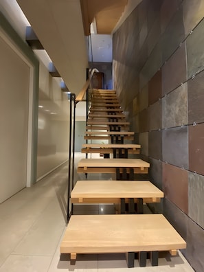 A modern interior with a wooden staircase and a minimalist design.
