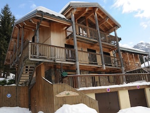A wooden chalet with multiple balconies and a ski lift visible in the background. - Charming apartment - 7 guests (Pralognan-la-Vanoise)