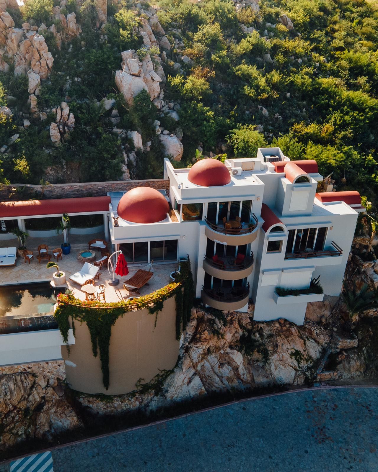 A modern building with multiple balconies and a swimming pool.
