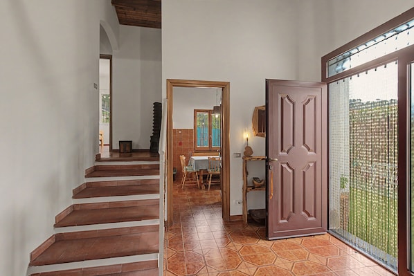 A staircase leading to a dining area with a view of the outdoors.