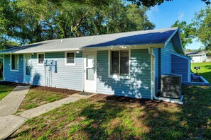 A single-story house with a front porch, a garage, and a small front yard. - Happy Hour Hideaway: Pool, Dock & Lake Access (Clermont)