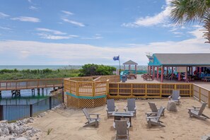 A beachside deck with wooden chairs, a gazebo, and a view of the ocean. - Ocean-view Balcony! Myrtle Beach Resort Getaway (Myrtle Beach)