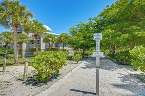 A pathway leading to a building with a sign indicating no motorized crafts allowed. - Secluded Island Escape on Little Gasparilla Island (Placida)