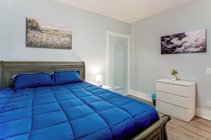 A bedroom with a bed, a dresser, a mirror, and two wall-mounted paintings. - 2-bedroom Bed & Breakfast in Adorable Lynn w/ A/C (Lynn)