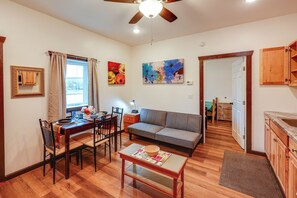 A cozy living room with a dining area, a sofa, and a ceiling fan. - Cozy Apartment Near UAF & Downtown Fairbanks! (Fairbanks)