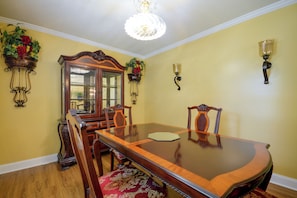 A dining room with a wooden table, chairs, a chandelier, and wall-mounted sconces. - 5 Mi to Vir! Private Escape w/ Yard & Decks (Milton)
