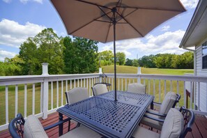 A deck with a table and chairs, a pergola with an umbrella, and a view of a green landscape. - 5 Mi to Vir! Private Escape w/ Yard & Decks (Milton)