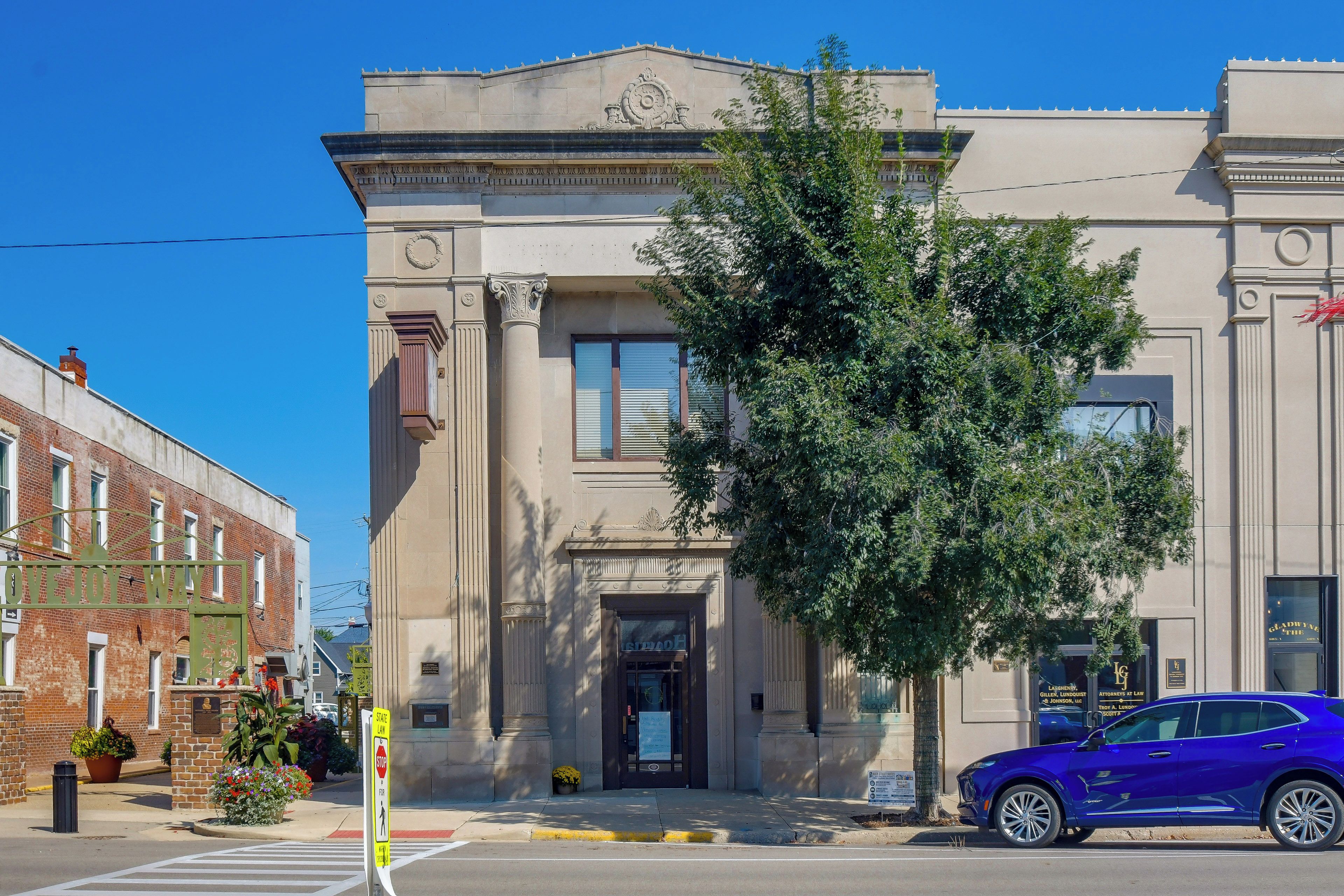 A building with a classical architectural style, featuring a prominent entrance with a door and windows.
