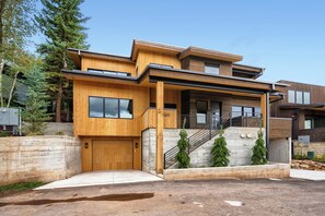 A modern two-story house with a wooden facade, a front porch, and a staircase leading to the upper level. - 1061 Lowell Avenue #4 (Park City)