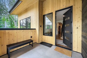 A wooden interior with a bench, a door, and a view of the outdoors. - 1061 Lowell Avenue #4 (Park City)