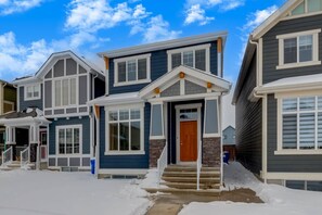 A row of two-story houses with a central entrance and a covered porch. - +Sleeps15 | 2Kitchens | 3 FamilyRooms | 5FullBaths (Calgary)