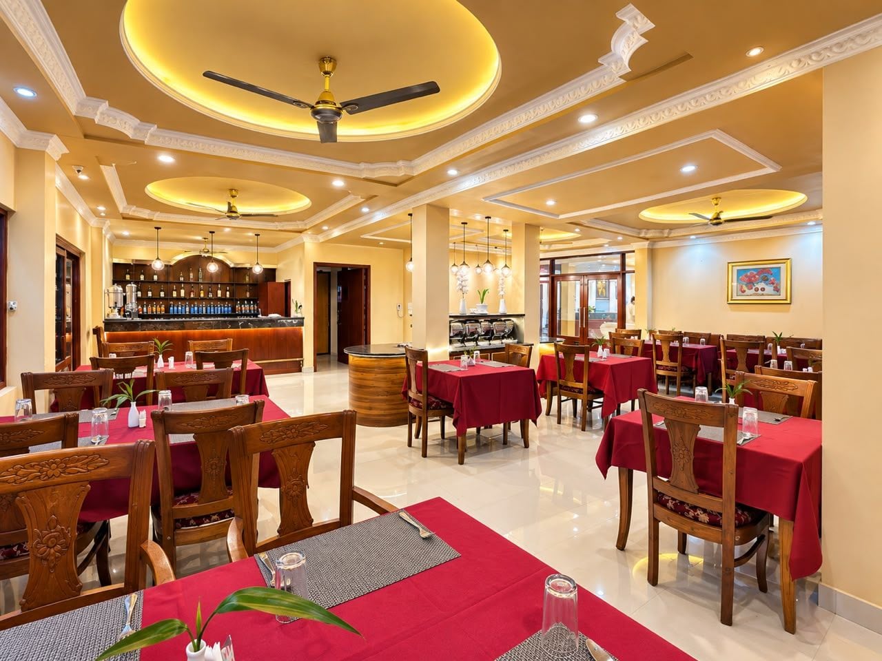 A restaurant with multiple tables, chairs, and a bar area.