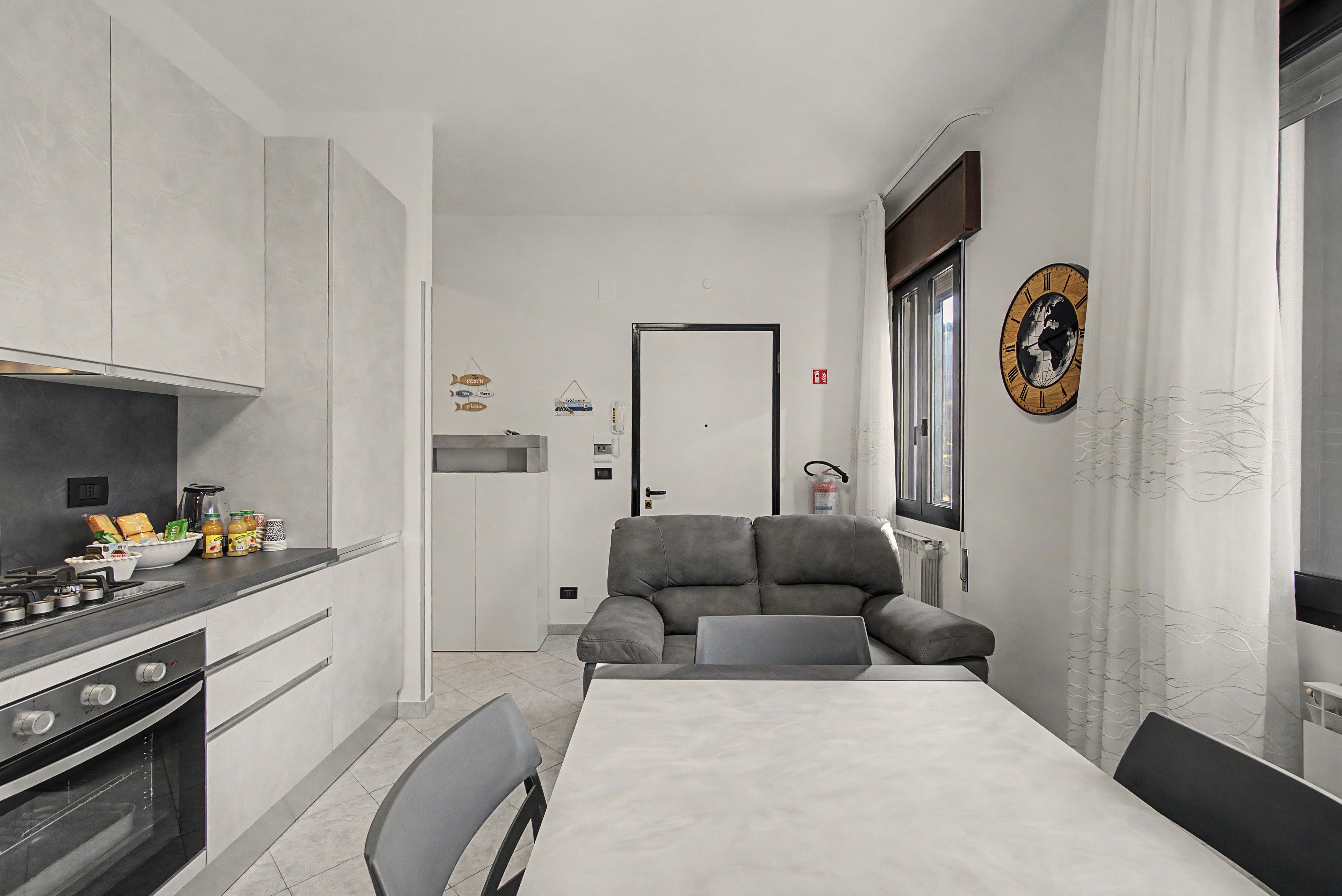 A compact kitchen with a stove, oven, and a dining area with a table and chairs.