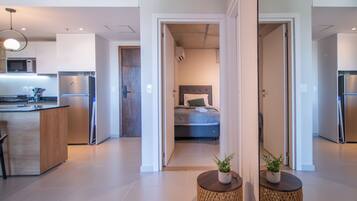 A modern apartment with a kitchen, a bedroom, and a living area.