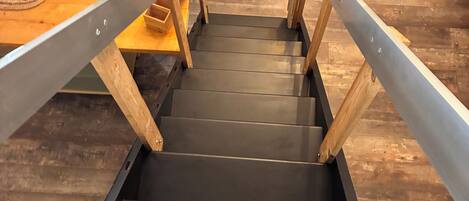 A staircase with wooden railings leading to a lower level.