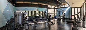A gym with exercise equipment, a treadmill, and a weight bench. - Imperial Ventures Apartments - 1 BR apt (Sandton)