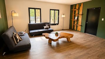 A modern living room with a sofa, a wooden coffee table, and a bench.