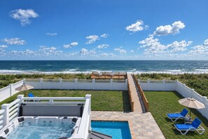 A rooftop pool area with a view of the ocean, a hot tub, and lounge chairs. - Direct Oceanfront-New Construction for 2027 (Kitty Hawk)