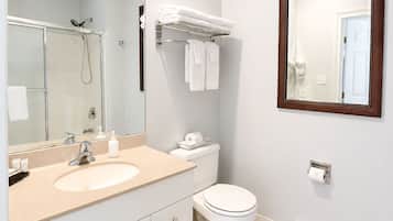 A modern bathroom with a sink, toilet, and shower.